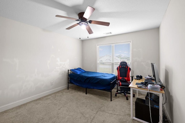 bedroom with a ceiling fan, baseboards, visible vents, and carpet