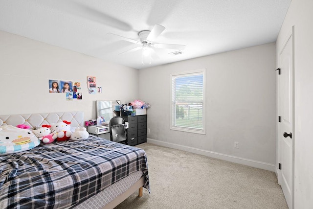 bedroom with visible vents, baseboards, ceiling fan, and light colored carpet