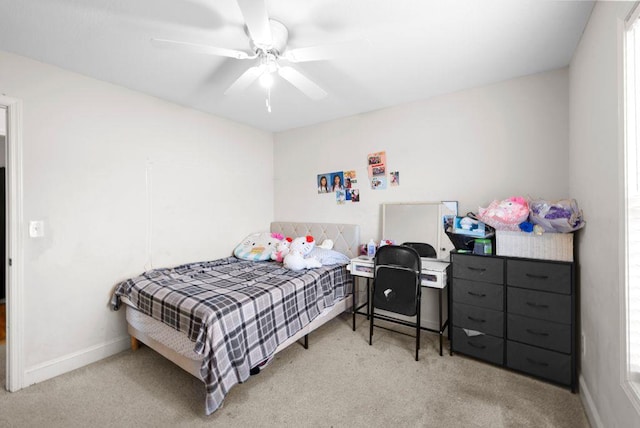 carpeted bedroom featuring ceiling fan and baseboards