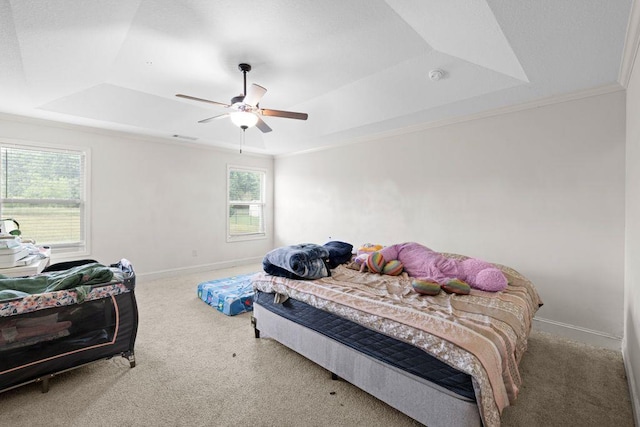 bedroom featuring crown molding, carpet floors, baseboards, and a tray ceiling
