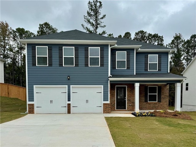 view of front of home with a front lawn, a porch, and a garage