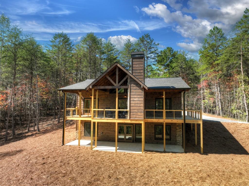 rear view of house with a deck and a patio area