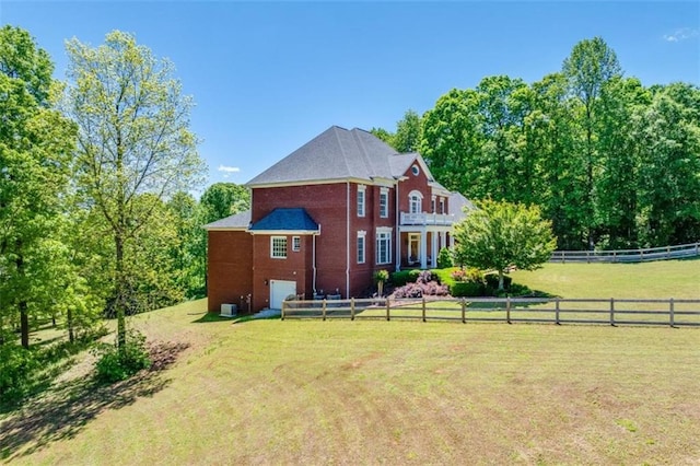 back of property with a lawn and a rural view