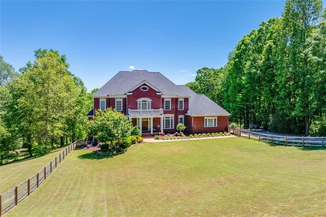 colonial home with a front lawn