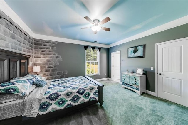 carpeted bedroom featuring ceiling fan and ornamental molding