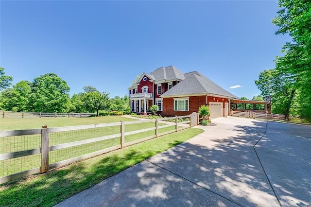 view of front of home featuring a garage, a rural view, and a front yard