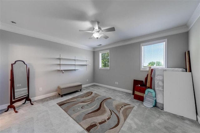 sitting room with light carpet, a healthy amount of sunlight, and ornamental molding