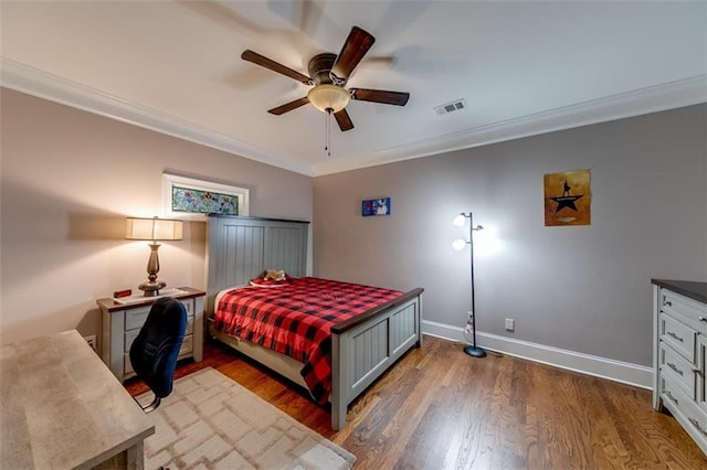 bedroom with ceiling fan, ornamental molding, and dark hardwood / wood-style flooring