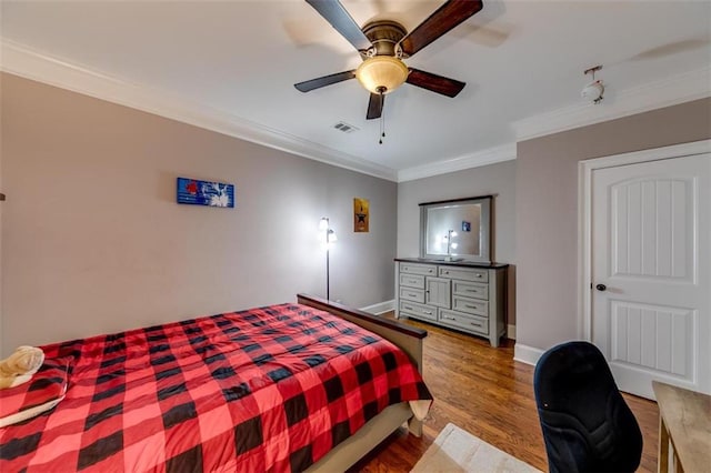 bedroom featuring wood-type flooring, ceiling fan, and ornamental molding