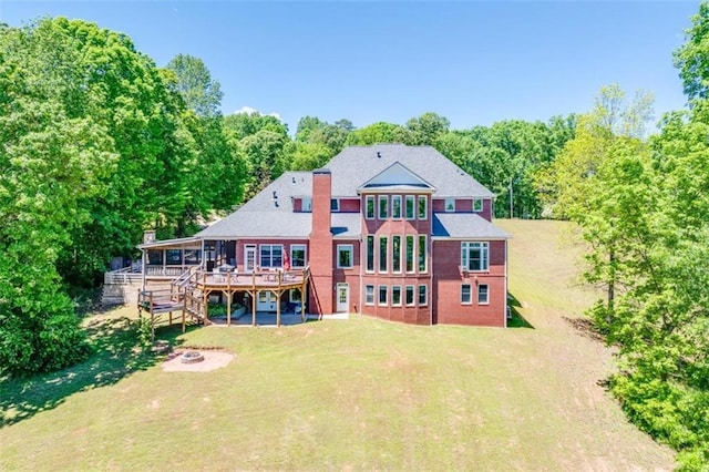 back of house with a lawn and a wooden deck