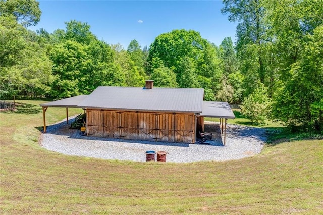 view of community featuring an outbuilding and a lawn