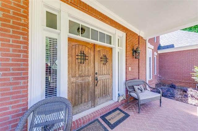 view of exterior entry with covered porch