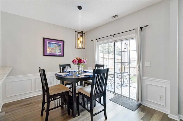113 Regent Pl, Woodstock, GA 30188 - dining space with wainscoting, a decorative wall, and wood finished floors