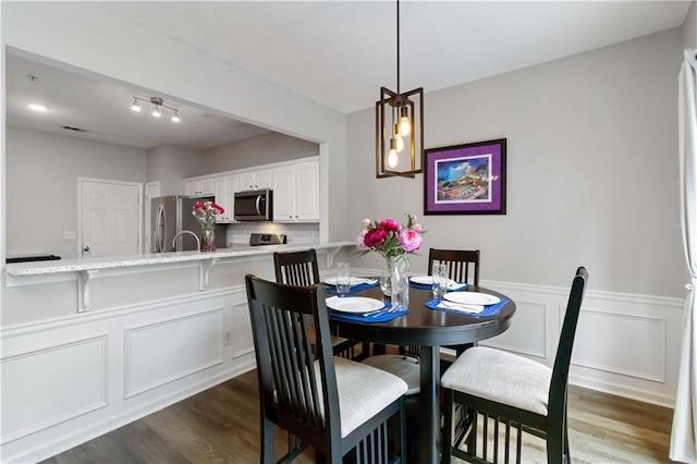 113 Regent Pl, Woodstock, GA 30188 - dining area featuring dark wood-style flooring, wainscoting, and a decorative wall