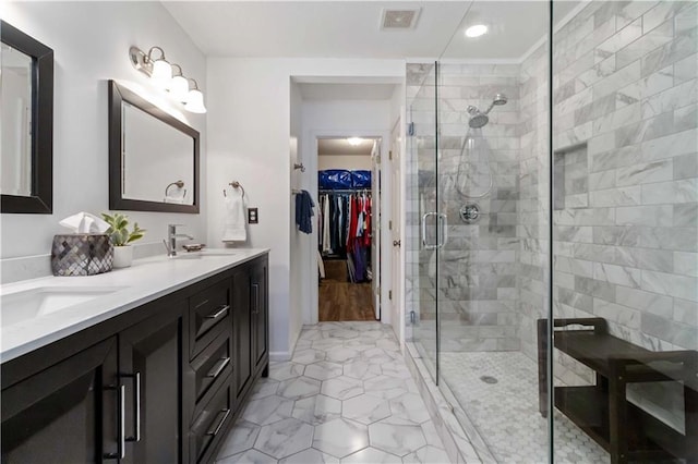 113 Regent Pl, Woodstock, GA 30188 - bathroom featuring double vanity, a shower stall, a spacious closet, tile patterned floors, and recessed lighting