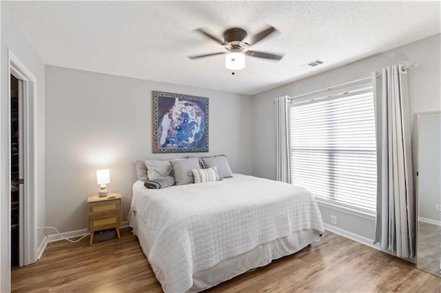 113 Regent Pl, Woodstock, GA 30188 - bedroom featuring light wood finished floors, baseboards, a textured ceiling, and ceiling fan