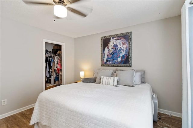 113 Regent Pl, Woodstock, GA 30188 - bedroom featuring wood finished floors, baseboards, ceiling fan, and a walk in closet