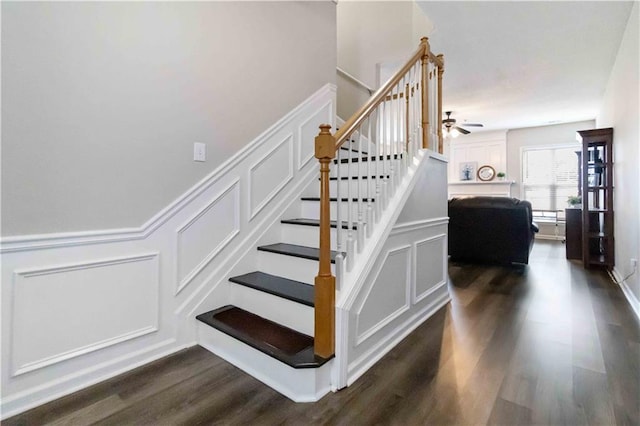 113 Regent Pl, Woodstock, GA 30188 - stairs with a decorative wall, wood finished floors, a ceiling fan, and wainscoting