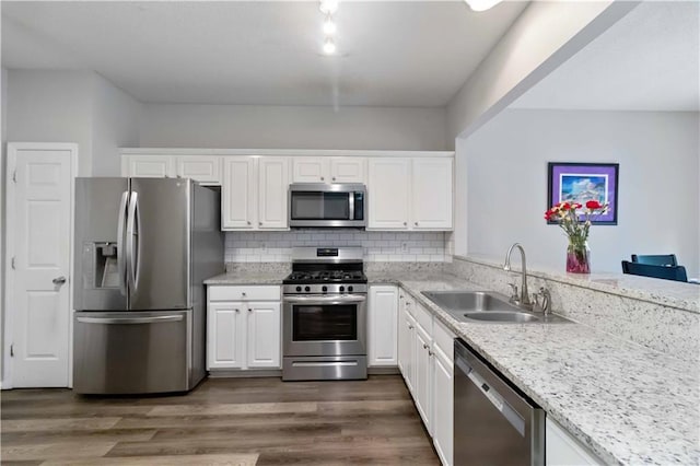 113 Regent Pl, Woodstock, GA 30188 - kitchen with stainless steel appliances, a sink, white cabinetry, and light stone countertops