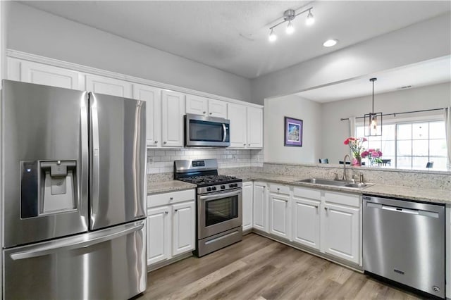 113 Regent Pl, Woodstock, GA 30188 - kitchen with stainless steel appliances, a sink, white cabinetry, and tasteful backsplash