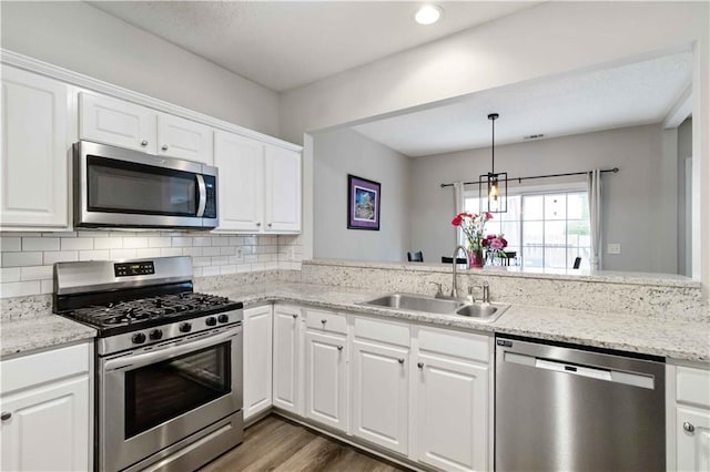 113 Regent Pl, Woodstock, GA 30188 - kitchen featuring appliances with stainless steel finishes, a sink, white cabinetry, dark wood-style flooring, and recessed lighting