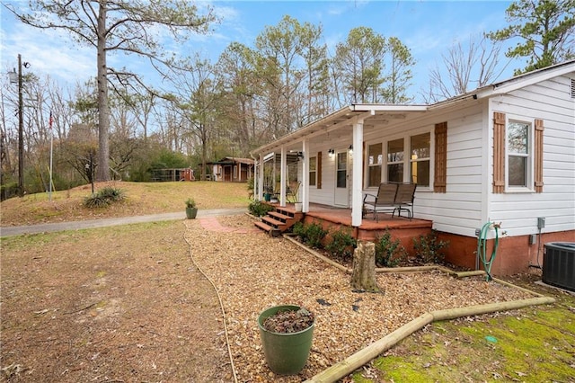 view of home's exterior with a porch and cooling unit