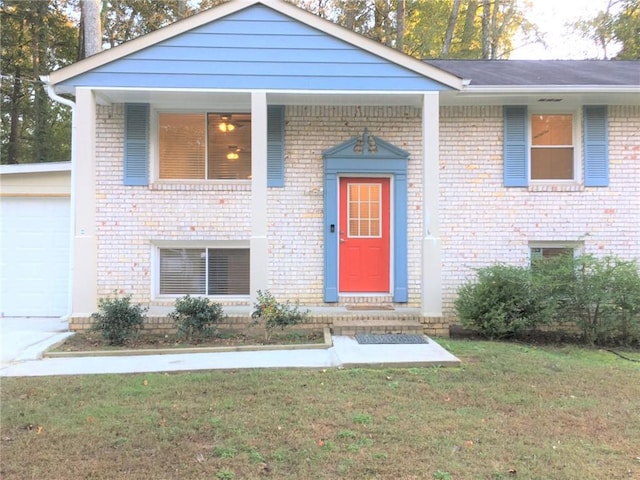 view of front of house with a front yard and a garage