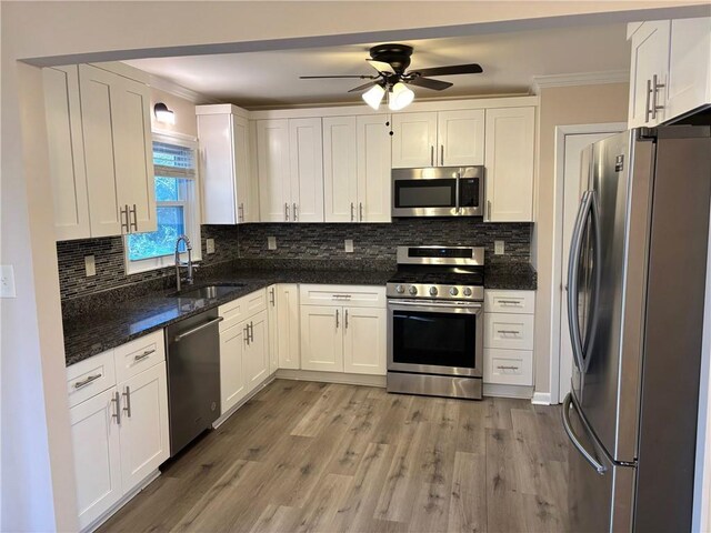 kitchen featuring stainless steel refrigerator with ice dispenser, white cabinets, ceiling fan, and ornamental molding