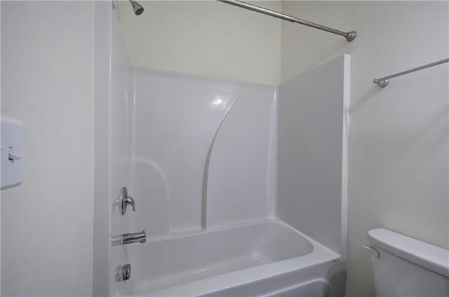 bathroom with shower / bathing tub combination and toilet