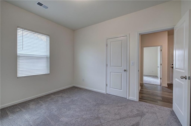 empty room featuring dark carpet