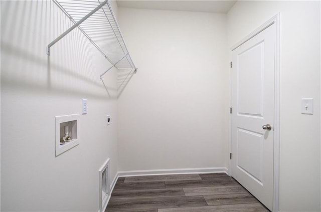 clothes washing area featuring washer hookup, hookup for an electric dryer, and dark hardwood / wood-style flooring