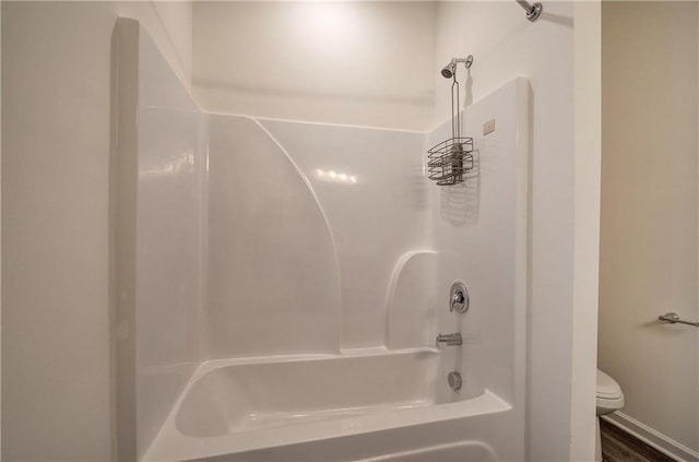 bathroom with shower / tub combination and toilet