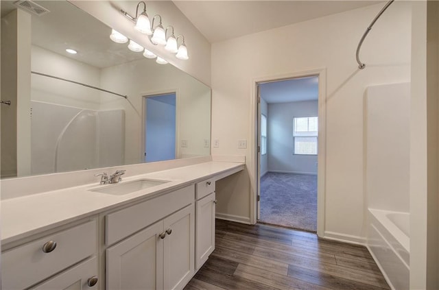 bathroom featuring vanity, tub / shower combination, and hardwood / wood-style floors