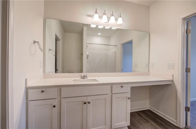 bathroom featuring vanity, hardwood / wood-style flooring, and walk in shower