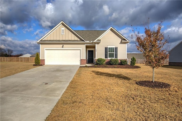 view of front of property featuring a garage and a front lawn