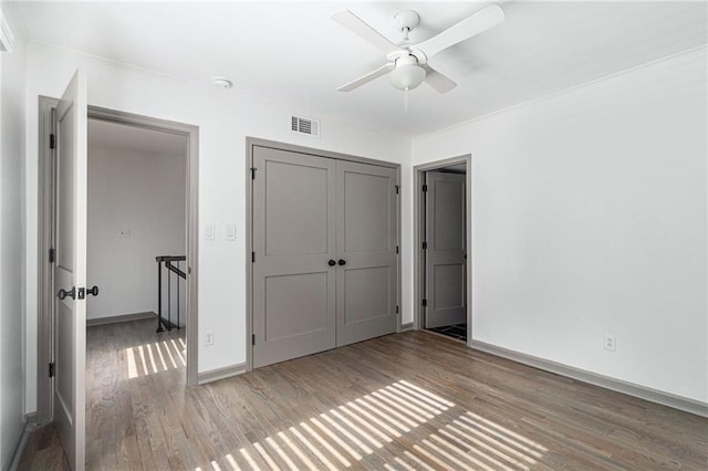 26 Ivy Pkwy NE, Atlanta, GA 30342 - unfurnished bedroom featuring wood finished floors, baseboards, a closet, and ceiling fan