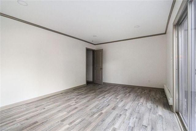 26 Ivy Pkwy NE, Atlanta, GA 30342 - empty room with a baseboard heating unit, crown molding, light wood-style floors, and baseboards