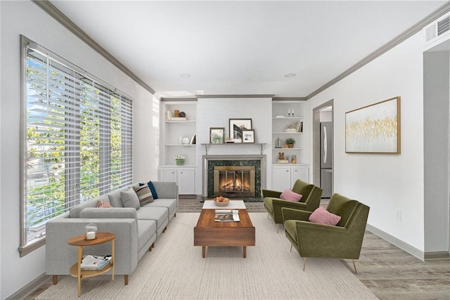 26 Ivy Pkwy NE, Atlanta, GA 30342 - living area with ornamental molding, baseboards, wood finished floors, a fireplace, and built in shelves