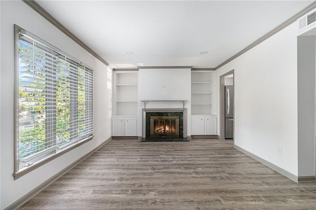 26 Ivy Pkwy NE, Atlanta, GA 30342 - unfurnished living room with ornamental molding, healthy amount of natural light, a premium fireplace, baseboards, and wood finished floors