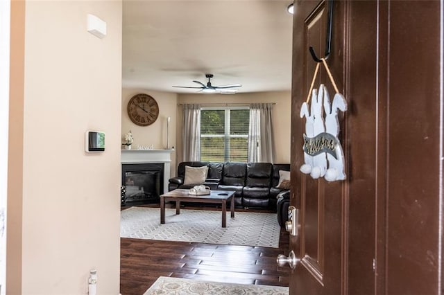 8553 Braylen Manor Dr, Douglasville, GA 30134 - living area with dark wood finished floors, a glass covered fireplace, and ceiling fan