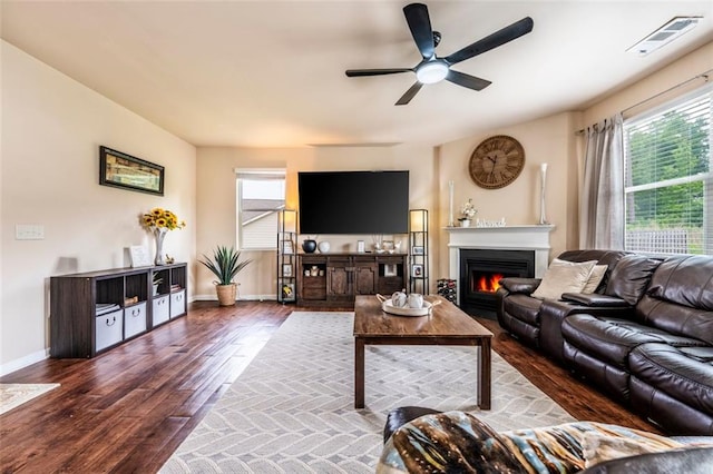8553 Braylen Manor Dr, Douglasville, GA 30134 - living area with wood finished floors, healthy amount of natural light, a lit fireplace, and ceiling fan