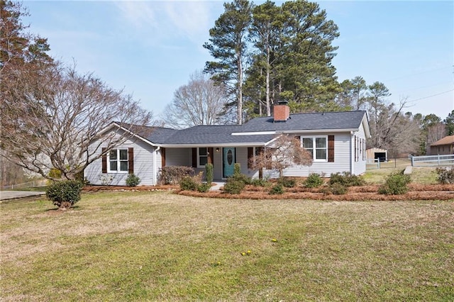 ranch-style home featuring a chimney, a front yard, and fence