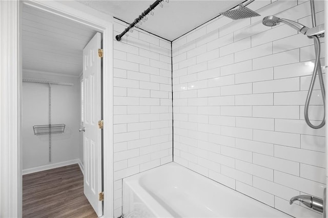 bathroom with shower / bath combination and wood finished floors