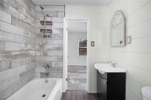 bathroom featuring vanity, wood finished floors, and shower / bath combination