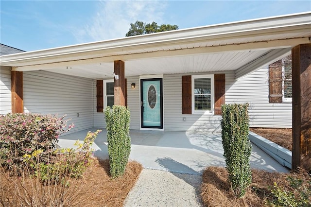 entrance to property with a carport and covered porch