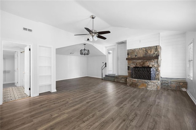 unfurnished living room with visible vents, ceiling fan, a stone fireplace, vaulted ceiling, and dark wood-type flooring