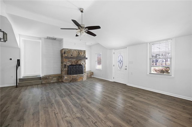 unfurnished living room with visible vents, baseboards, ceiling fan, a stone fireplace, and dark wood-style flooring