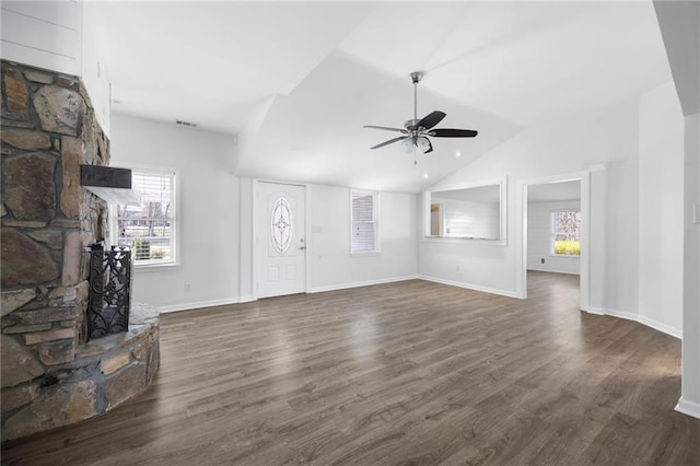 unfurnished living room featuring a wealth of natural light, lofted ceiling, ceiling fan, and dark wood-style flooring