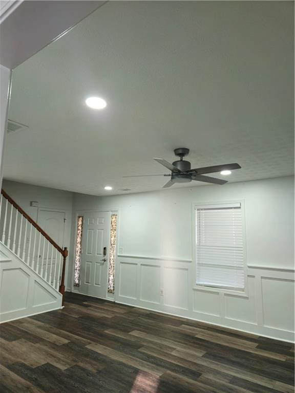 entrance foyer with dark wood-type flooring, recessed lighting, a decorative wall, ceiling fan, and stairs