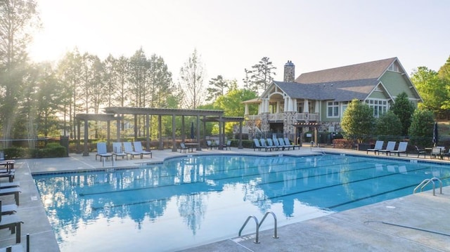 pool featuring a patio area, a pergola, and fence